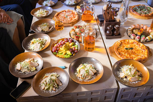 Food concept, table with various snacks placed on it. Salad with salmon, caesar skuric, pickled mushrooms, bread