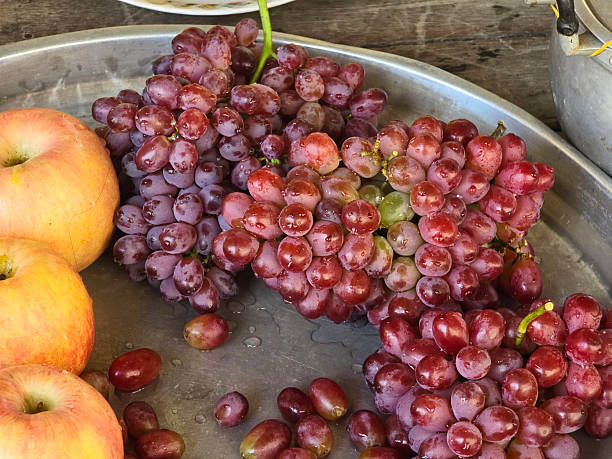 Various grapes and fruits are placed in the basket