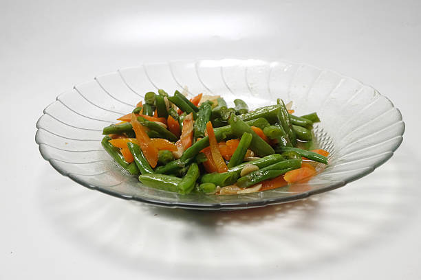 man preparing a festive dinner, baking vegetables in the oven