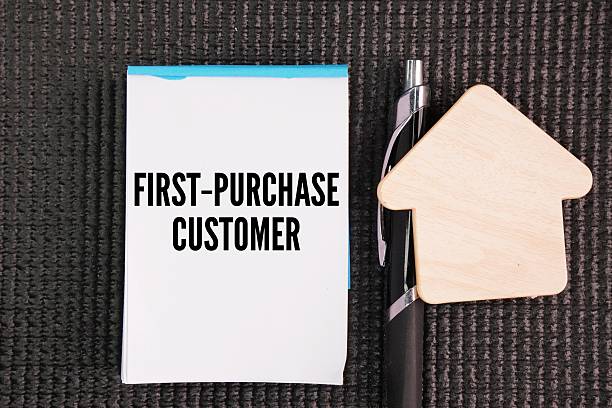istock House-shaped pen and white paper with the words First-Purchase Customer. 2254554172