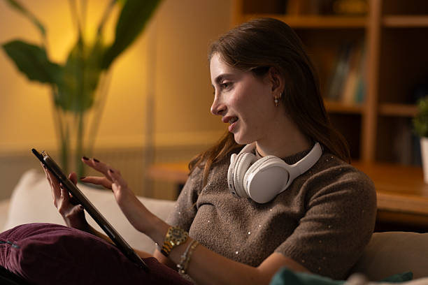 istock Young woman relaxing at home using digital tablet 2254556422