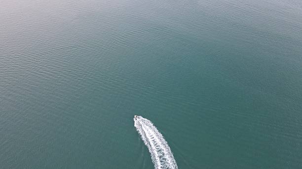 istock A small yacht sailing fast on the sea with long waves 2254560597