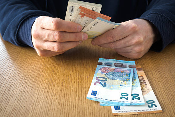 istock Euro banknotes on the table, men's hands. 2254560740