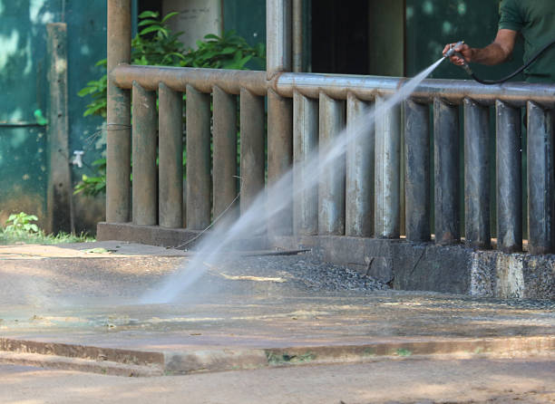 istock A man is spraying water on a sidewalk 2254561252
