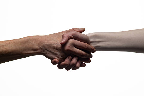 istock Two hands clasping in a handshake, symbolizing agreement, unity, or trust, against a white background. Includes copy space for text or design elements 2254569363