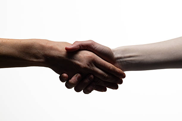 istock Two hands clasping in a handshake, symbolizing agreement, unity, or trust, against a white background. Includes copy space for text or design elements 2254569371