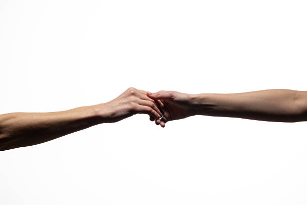 istock Close-up of two hands gently touching against a white background, symbolizing connection, support, or love. Includes ample copy space 2254569393