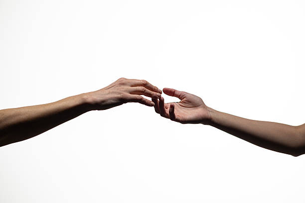 istock Two human hands reaching out and almost touching against a plain white background, symbolizing longing, connection, or separation. Includes copy space 2254572087