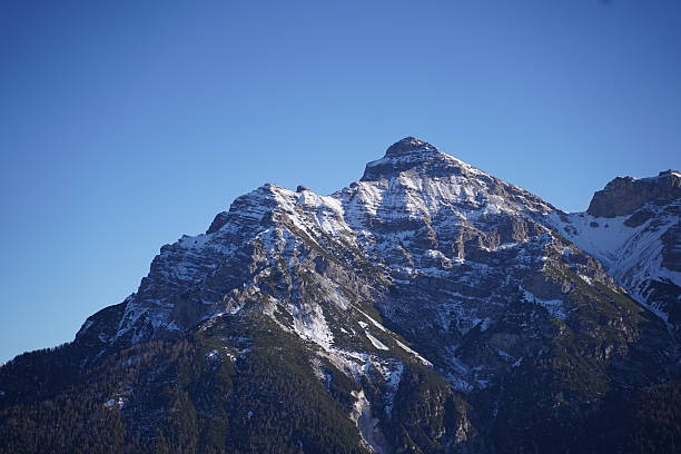 istock Snow-Capped Mountain Peak under Clear Blue Sky 2254574886