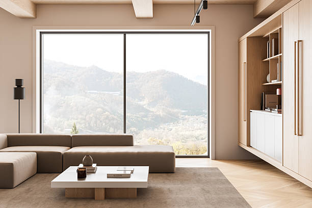 Interior of a modern cozy lake house with fireplace and Christmas decorations in the winter.