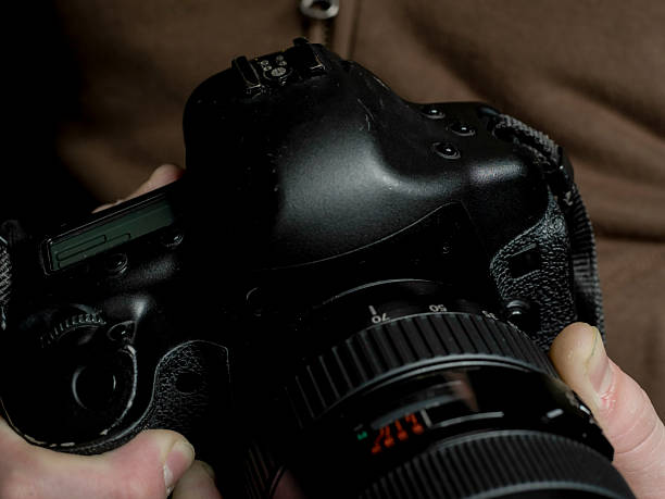 istock Photographer Holding DSLR Camera 2254576381