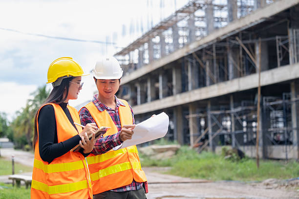 istock Construction team collaborating on project plans building site image outdoor close-up teamwork in action 2254576488