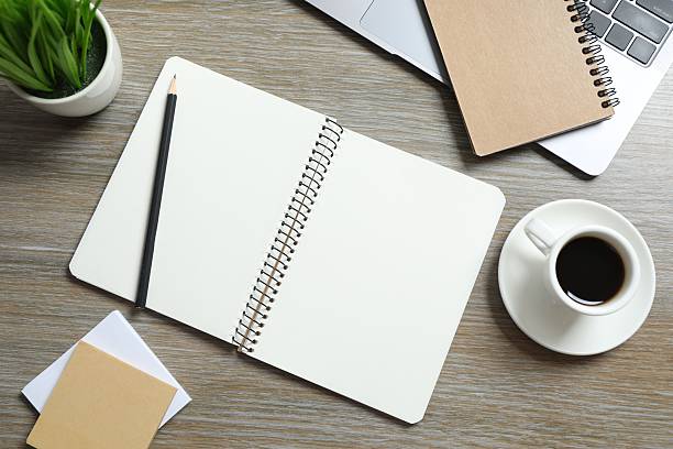 istock Workplace with laptop, pencil, notebook and coffee cup, top view 2254576898