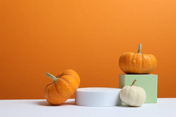 istock White podiums with pumpkins on two tone background 2254577585