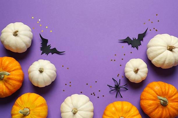 istock Different Halloween decorations including pumpkins, spiders and bats with confetti on color background 2254577586