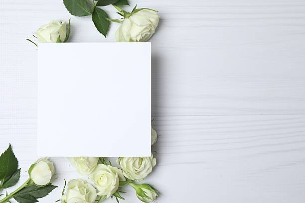istock Beautiful white roses with paper card on light background 2254579515