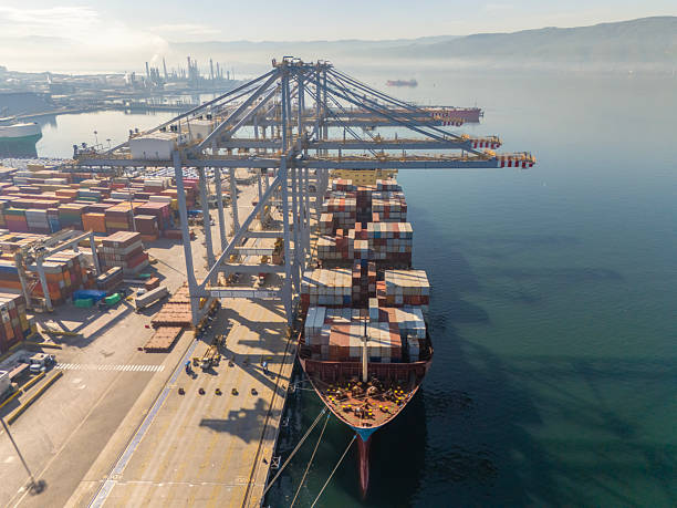 istock Aerial Front View of Massive cargo container ship loaded with containers docked in an International Port. 2254580872