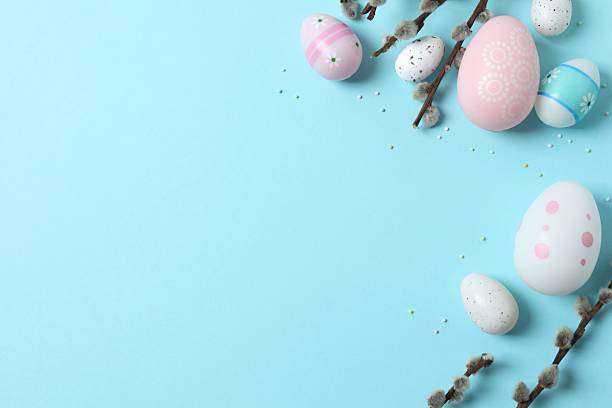 istock Colorful eggs, pussy willow branches, sweet sprinkles on a pastel beige background, space for text or advertising 2254581103
