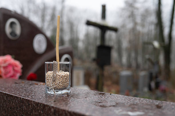 istock Cemetery remembrance: grave marker with candle and flowers 2254581430