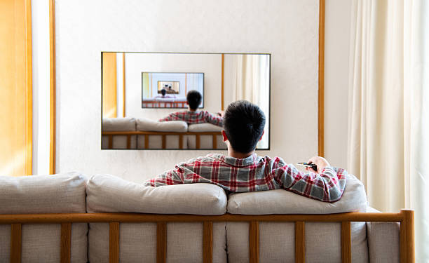 Teenage boy watching tv at home with same image in frame. The photos on the TV were also taken by me