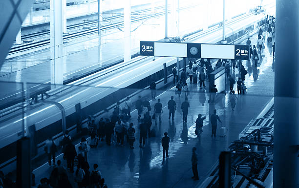 People and commuters walking on train station platform