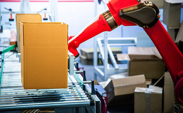 istock Robotic arm carrying carton box on conveyor belt 2254582603