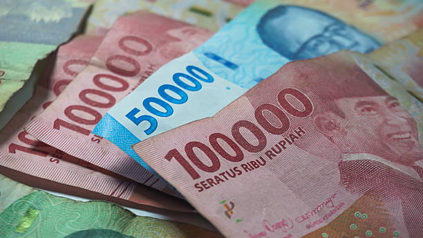 istock blue Indonesian banknotes worth fifty thousand rupiah among the notes worth one hundred thousand rupiah. 2254582915