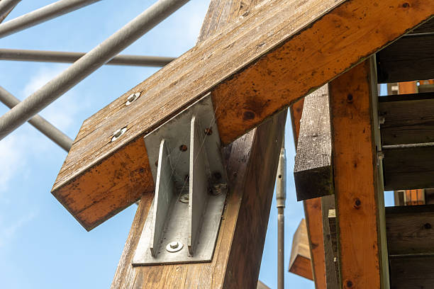 Detailed view of wooden beam structure joint in an architectural framework, showcasing the craftsmanship and intricate woodworking in a construction project.