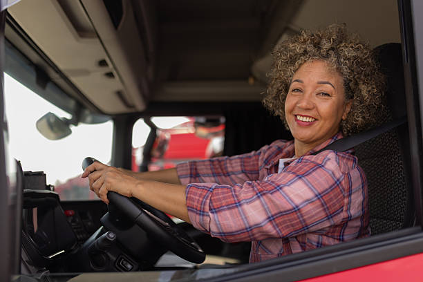 istock Female Truck Driver Looking at Camera During Work Break 2254585438