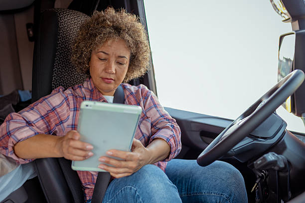 istock Female Truck Driver Using Digital Tablet Inside Truck Cab 2254585502