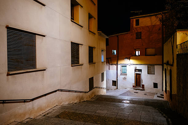 An old city street with staircase in Spain at night