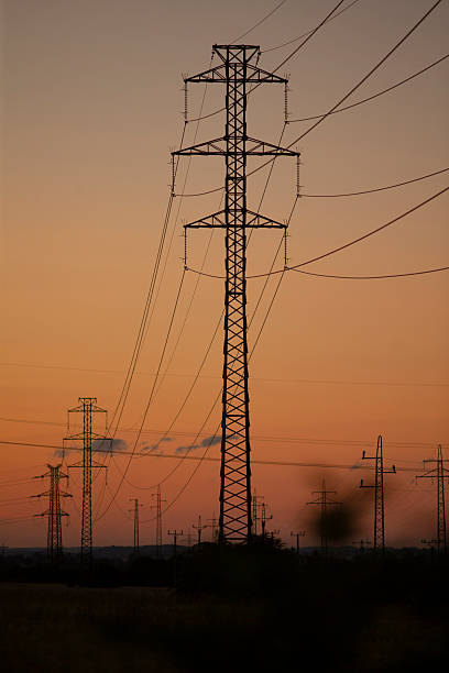 istock Lattice transmission tower depicted against softly lit evening sky 2254589836