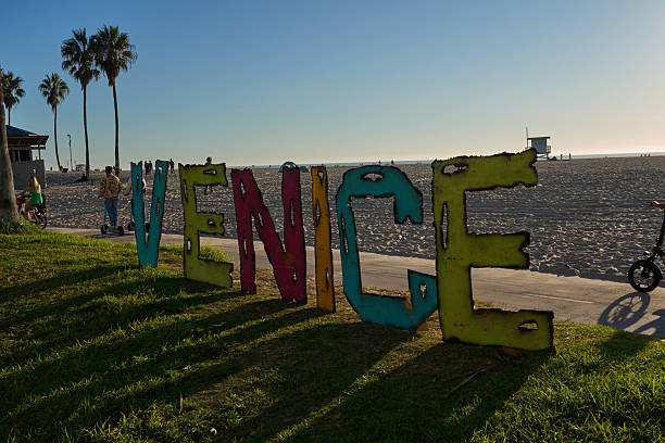 Los Angeles, USA - October 18, 2025 - Venice Beach - Lifeguard tower and beach buildings under a clear blue sky on a sandy shore