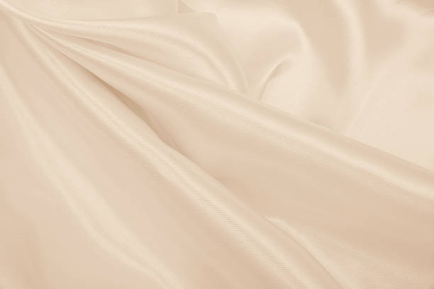 istock Smooth elegant golden silk or satin luxury cloth texture as wedding background. Luxurious Christmas background or New Year background design. In Sepia toned. Retro style 2254591776