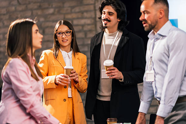 istock Eco-Friendly Coffee Break - Business Colleagues Using Sustainable Paper Cups 2254591995