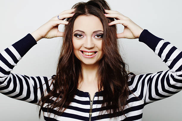 Beauty portrait of brown hair smiling young woman isolated on white background.