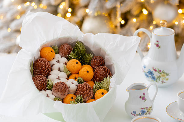 istock Zephyr arrangement featuring pine cones, cotton bolls, and oranges nestled in white tissue paper, creating a festive atmosphere with natural elements and seasonal charm 2254596263