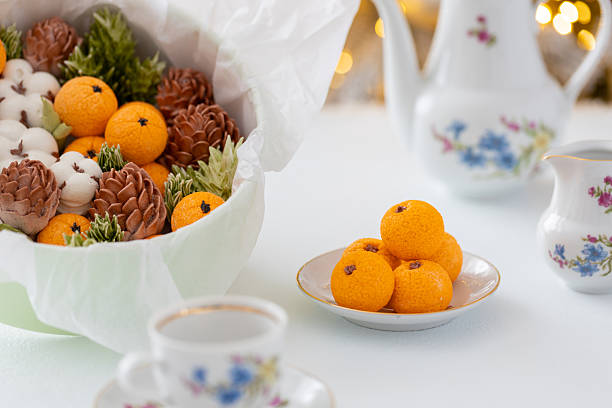 istock Zephyr arrangement featuring pine cones, cotton bolls, and oranges nestled in white tissue paper, creating a festive atmosphere with natural elements and seasonal charm 2254596265