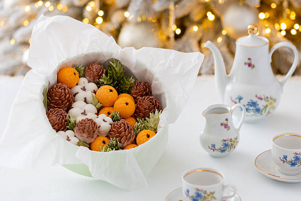istock Zephyr arrangement featuring pine cones, cotton bolls, and oranges nestled in white tissue paper, creating a festive atmosphere with natural elements and seasonal charm 2254596271