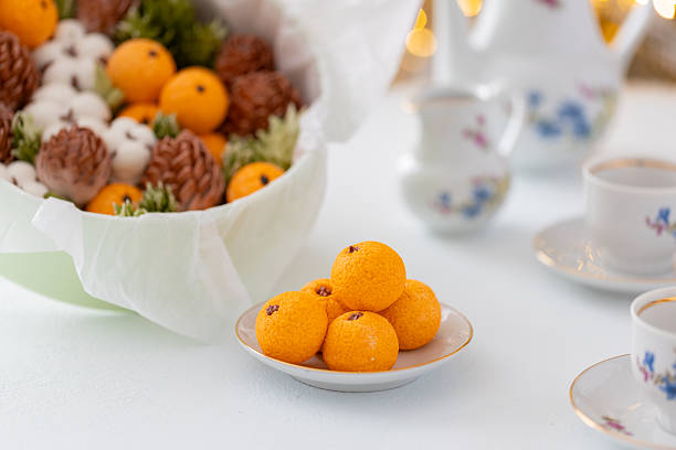 istock Zephyr arrangement featuring pine cones, cotton bolls, and oranges nestled in white tissue paper, creating a festive atmosphere with natural elements and seasonal charm 2254596272