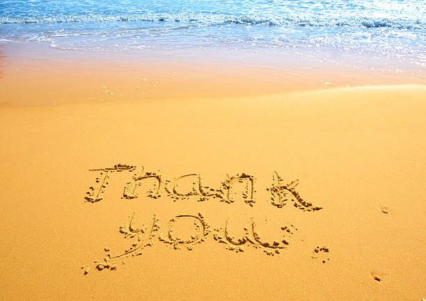 istock Thank you written in the sand on the beach. 2254598080