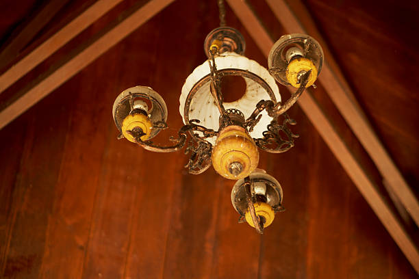 Vintage Chandelier Hanging from Exposed Beam Ceiling