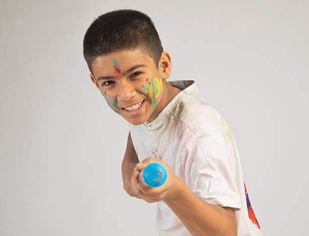 istock Happy boy playing with squirt gun on white background 2254599452