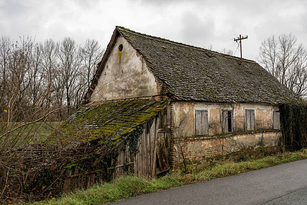 Beautiful old abandoned building farm house in countryside on natural background, photography consisting of old abandoned building farm house at wild grass, old abandoned building farm house over sky