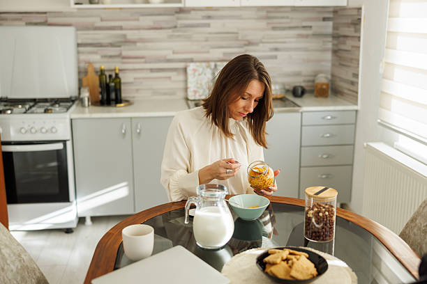 istock Business woman having breakfast at home 2254601945