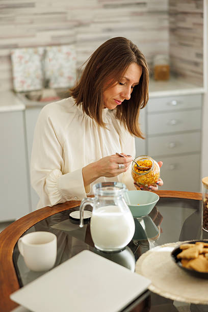 istock Business woman having breakfast at home 2254602026