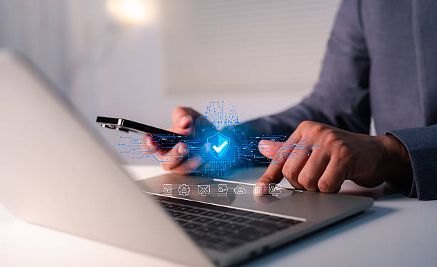 istock Hand of a man using mobile phone and laptop, secure access to user personal information, secure Internet access, information security encryption. Cybersecurity internet network data privacy concepts. 2254602111
