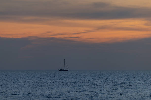 Sun is setting on Andaman sea with multi colored clouds.Phuket Island - Thailand.