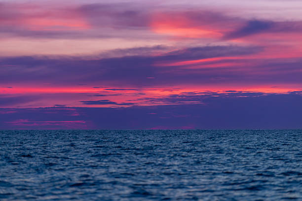Sun is setting on Andaman sea with multi colored clouds.Phuket Island - Thailand.