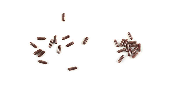 istock Iron capsule isolated, Fe pills, brown hemoglobin supplement tablets, vitamin capsules on white 2254608285